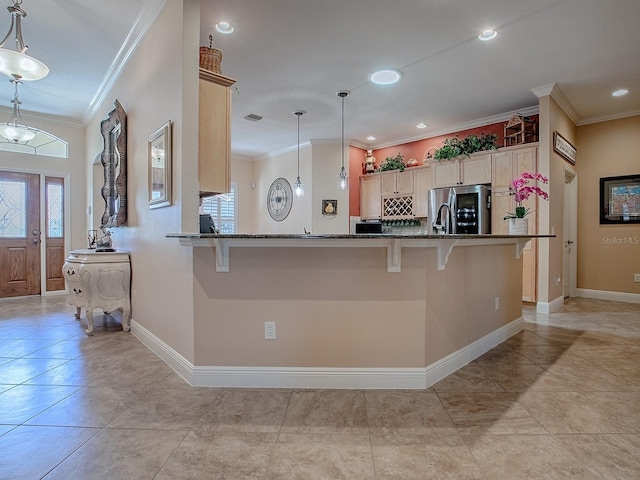 kitchen featuring dark stone countertops, a kitchen breakfast bar, stainless steel fridge with ice dispenser, and ornamental molding