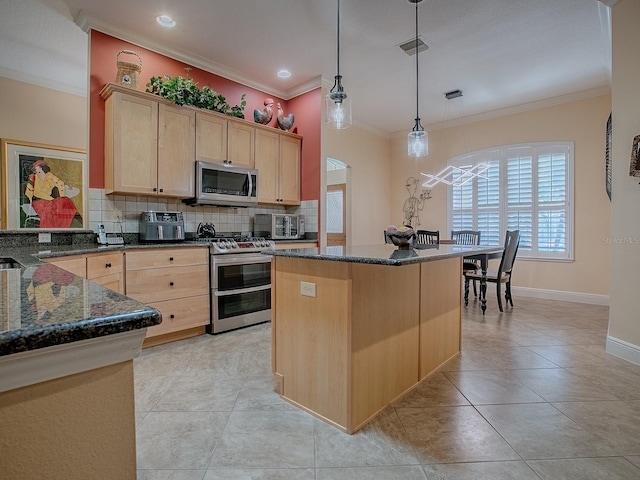 kitchen featuring dark stone countertops, visible vents, light brown cabinetry, appliances with stainless steel finishes, and backsplash