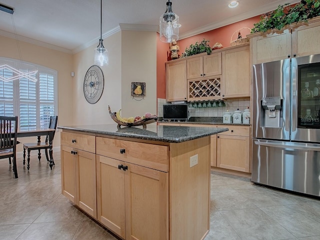 kitchen featuring tasteful backsplash, a kitchen island, crown molding, light brown cabinetry, and stainless steel fridge