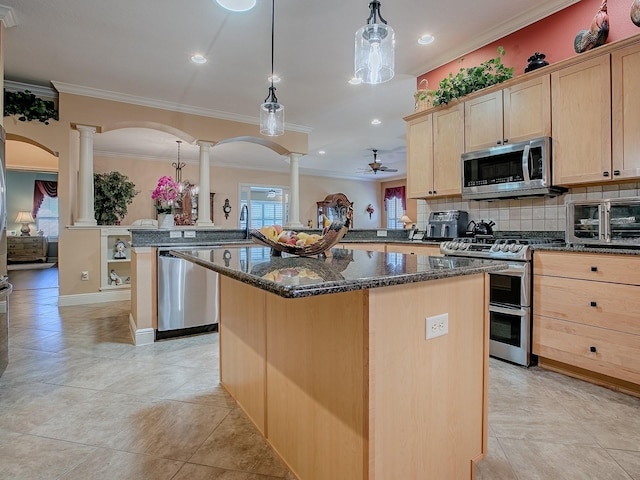 kitchen featuring decorative columns, a kitchen island, light brown cabinetry, and stainless steel appliances