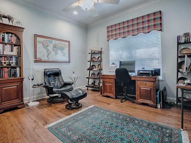 office space with baseboards, light wood-style floors, a ceiling fan, and ornamental molding