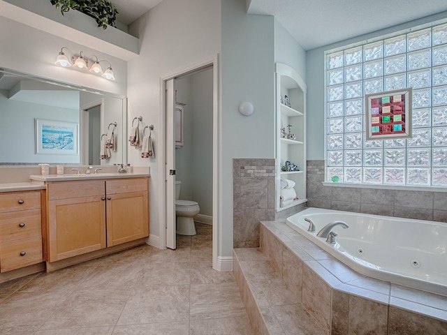 full bathroom with a wealth of natural light, built in shelves, toilet, and a whirlpool tub