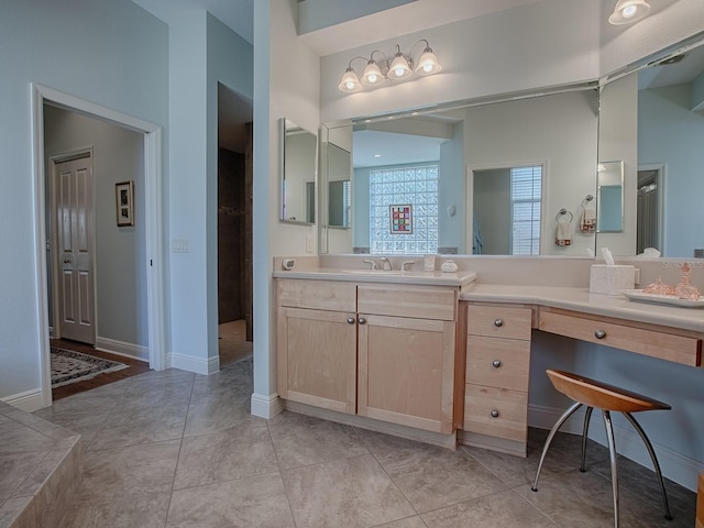 full bath with tile patterned flooring, vanity, and baseboards