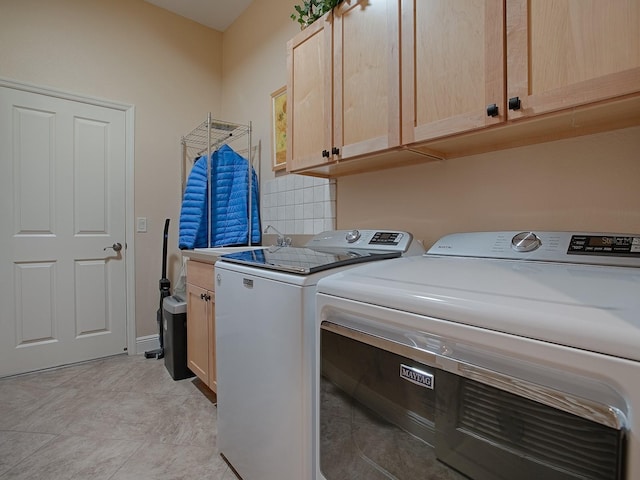 laundry room featuring cabinet space and separate washer and dryer