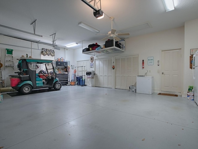 garage with a garage door opener, fridge, and ceiling fan