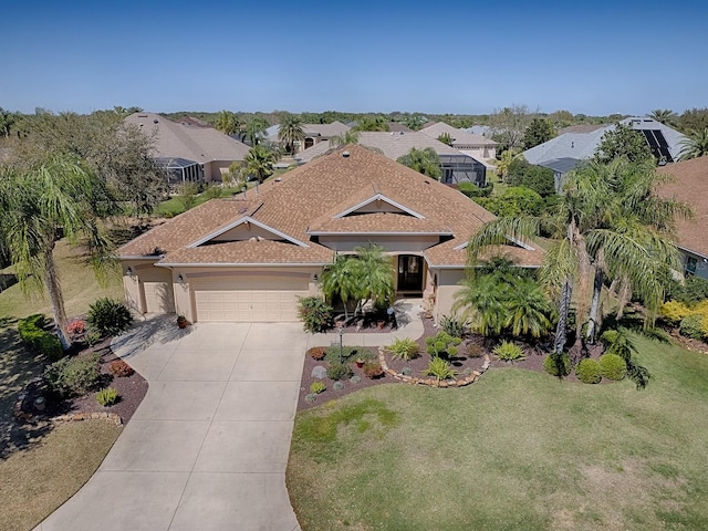 view of front of home featuring driveway, a front yard, a garage, and roof with shingles