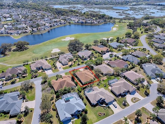 aerial view featuring golf course view, a residential view, and a water view