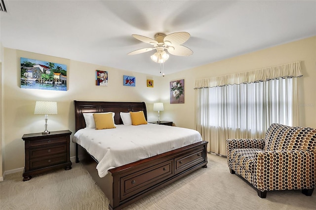 bedroom featuring visible vents, baseboards, light colored carpet, and ceiling fan