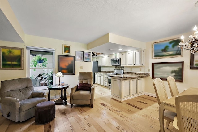 living room featuring baseboards, light wood finished floors, and a chandelier