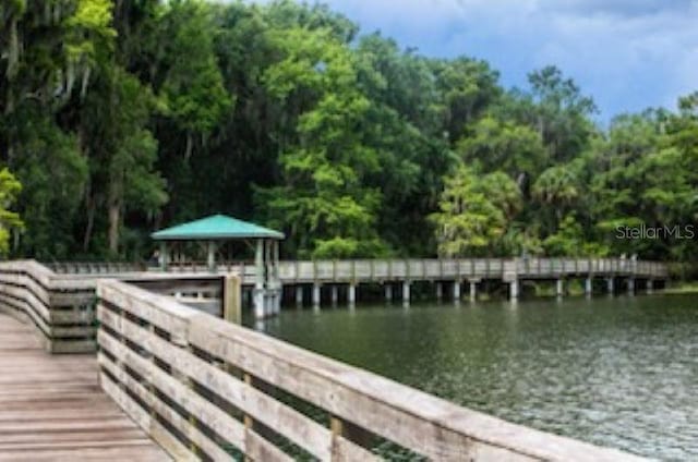 view of dock with a gazebo and a water view