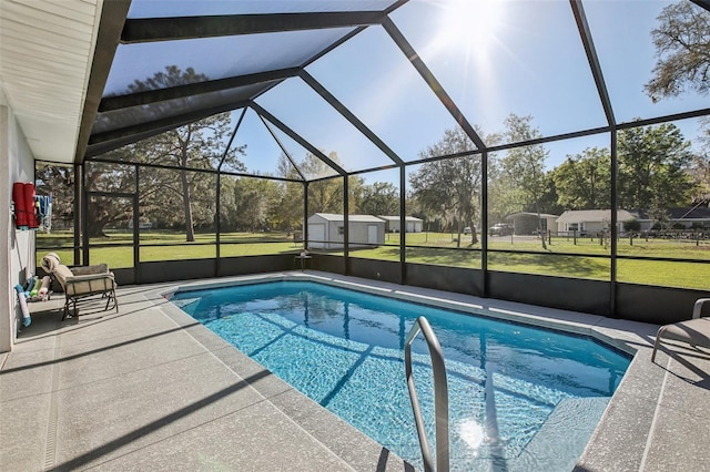 pool featuring an outbuilding, a yard, a storage unit, a lanai, and a patio area