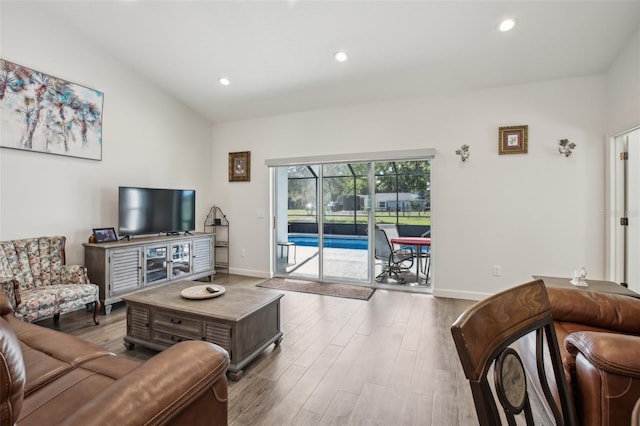 living room featuring recessed lighting, wood finished floors, and baseboards