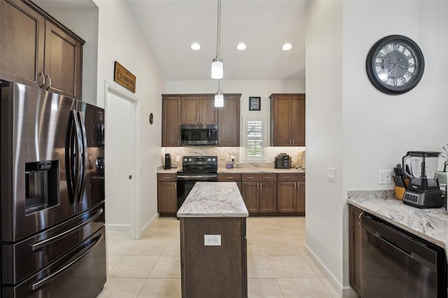 kitchen featuring tasteful backsplash, light tile patterned floors, stainless steel appliances, and decorative light fixtures