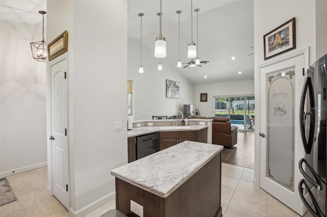 kitchen featuring an inviting chandelier, freestanding refrigerator, a sink, dishwasher, and open floor plan