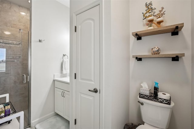 bathroom featuring a stall shower, toilet, and baseboards