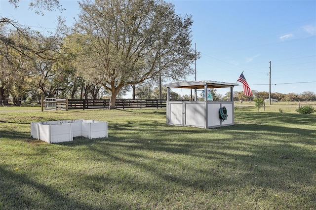 view of yard featuring an outbuilding and fence