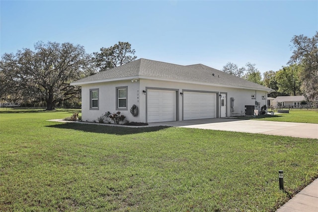 view of front of property featuring a front yard, a shingled roof, stucco siding, concrete driveway, and a garage