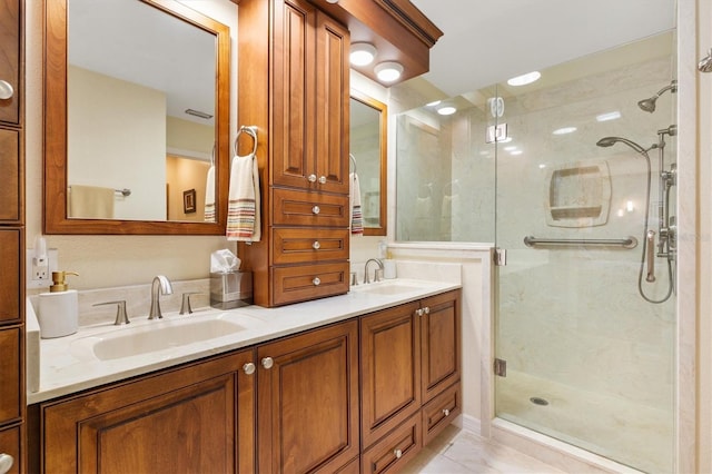 full bath featuring double vanity, a stall shower, and a sink