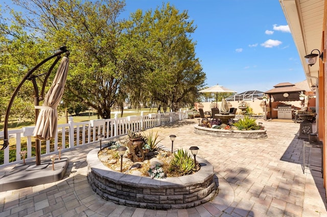 view of patio / terrace with a grill and fence