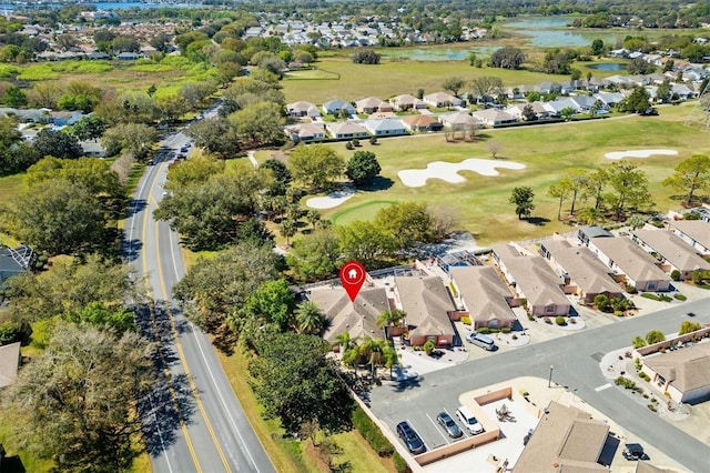 bird's eye view featuring view of golf course, a residential view, and a water view