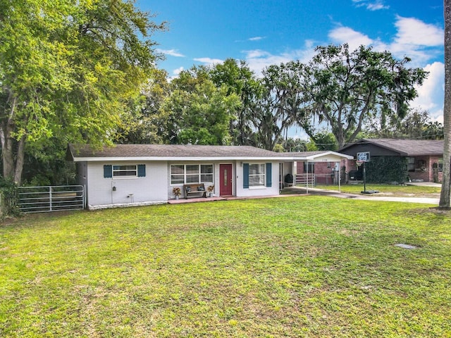 ranch-style house with brick siding, a front yard, and fence