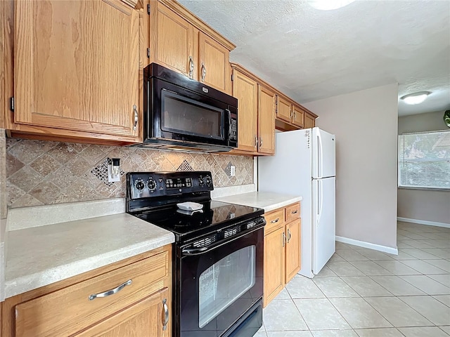 kitchen with decorative backsplash, black appliances, light tile patterned flooring, and light countertops