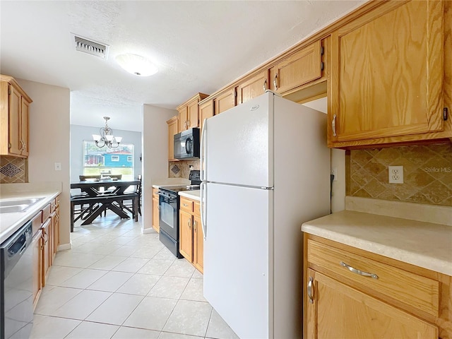 kitchen featuring visible vents, an inviting chandelier, light tile patterned flooring, black appliances, and light countertops