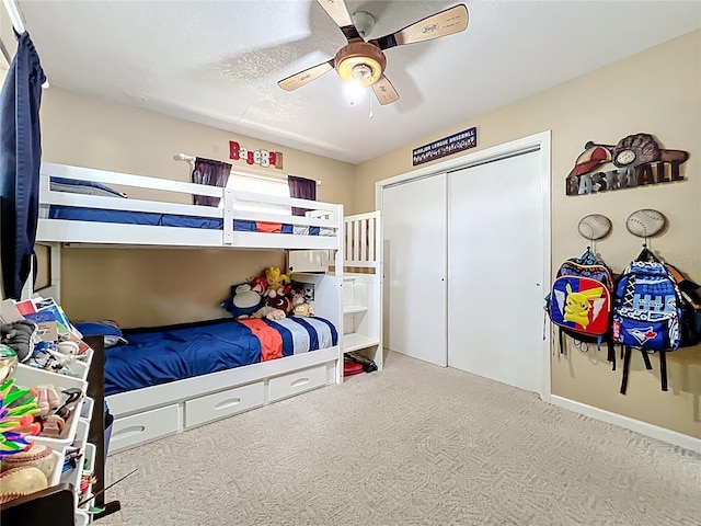 carpeted bedroom featuring a closet and ceiling fan