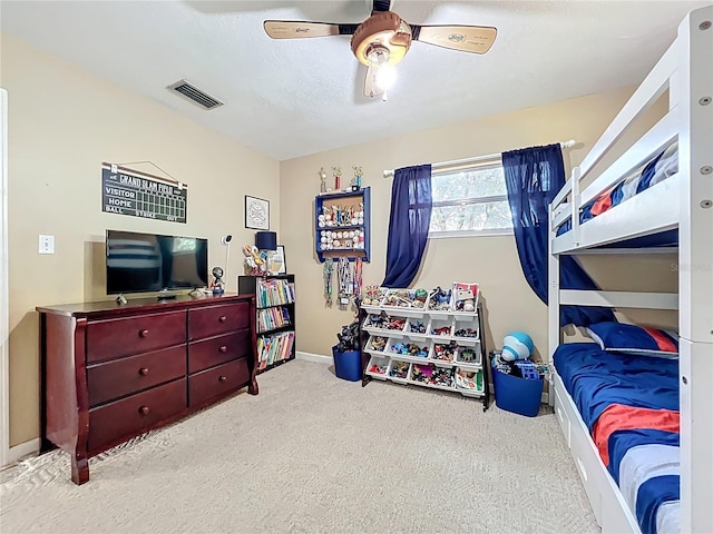 carpeted bedroom featuring visible vents, baseboards, and a ceiling fan