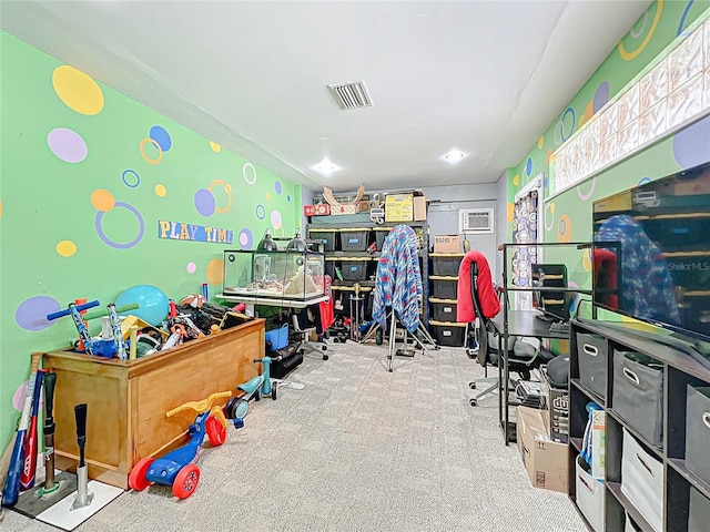 playroom featuring visible vents, carpet floors, and a wall mounted AC