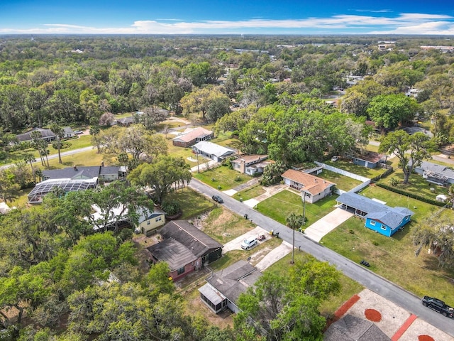 birds eye view of property featuring a residential view and a wooded view