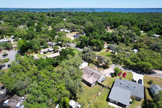 aerial view with a forest view and a water view