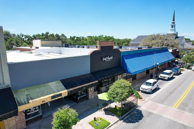 view of building exterior with uncovered parking