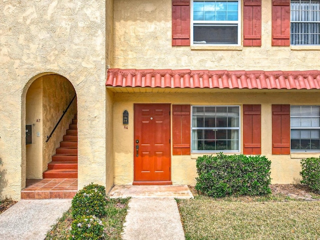 property entrance with stucco siding