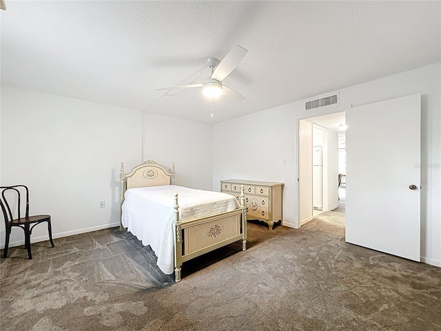 bedroom with visible vents, baseboards, ceiling fan, carpet flooring, and a textured ceiling