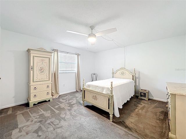 bedroom featuring baseboards, dark carpet, and ceiling fan