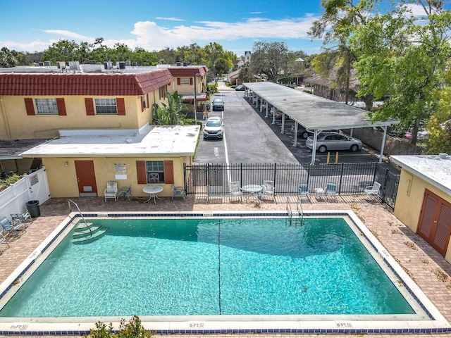 pool featuring a patio area and fence