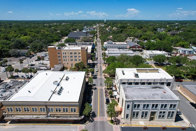 bird's eye view with a wooded view