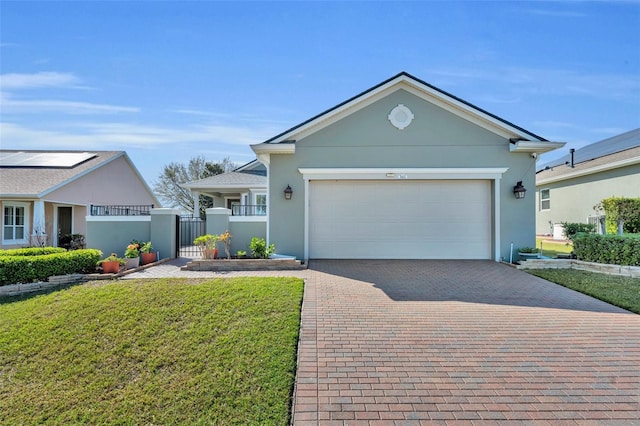 ranch-style house featuring a gate, decorative driveway, a garage, and stucco siding