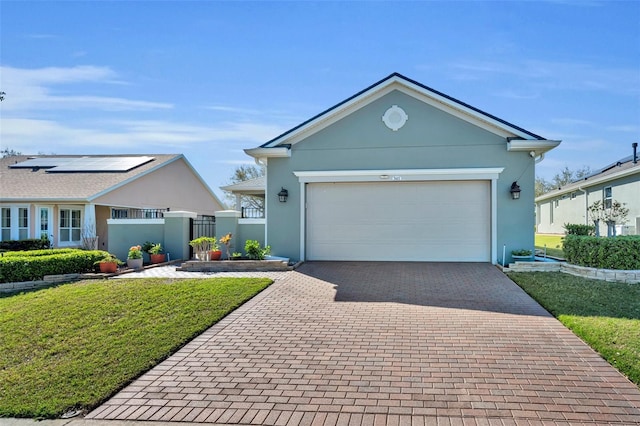 ranch-style home featuring fence, stucco siding, decorative driveway, a garage, and a gate