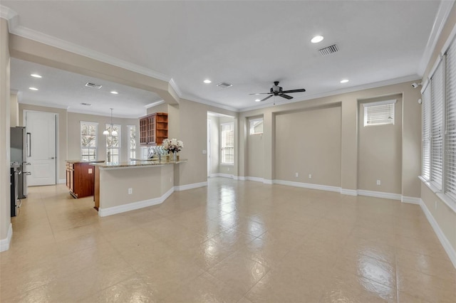 unfurnished living room featuring recessed lighting, a ceiling fan, visible vents, and a wealth of natural light