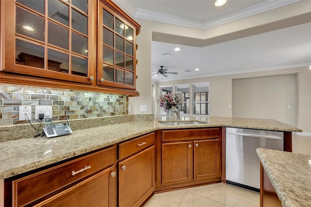 kitchen featuring stainless steel dishwasher, crown molding, light stone counters, and a sink