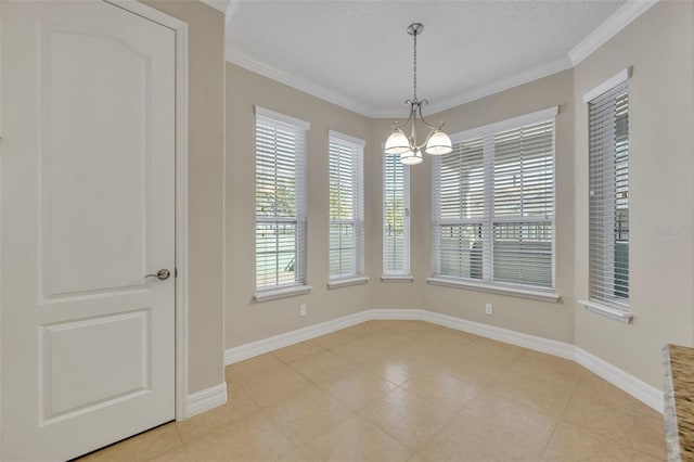 interior space with baseboards, a healthy amount of sunlight, a chandelier, and ornamental molding