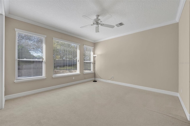 spare room featuring light carpet, ceiling fan, and ornamental molding