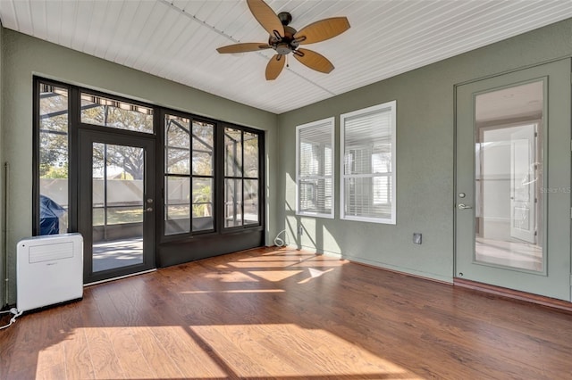 unfurnished sunroom with a wealth of natural light, ceiling fan, and wooden ceiling