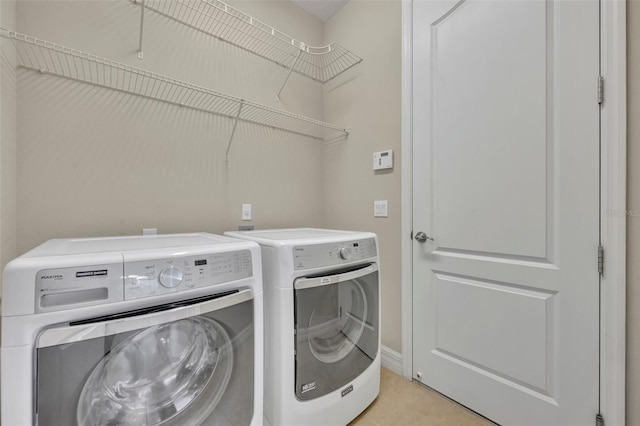 clothes washing area featuring laundry area and separate washer and dryer