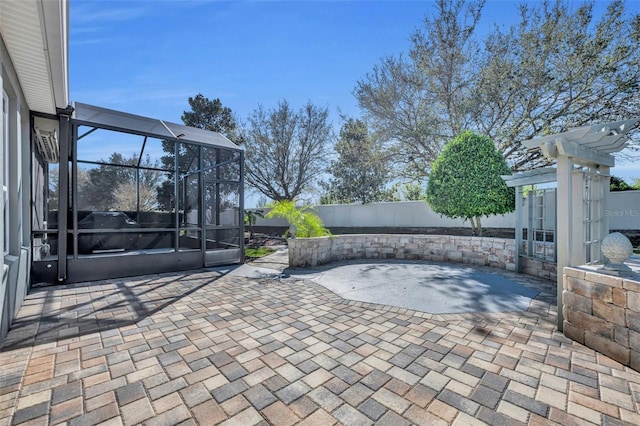 view of patio featuring glass enclosure, a fenced backyard, and a pergola