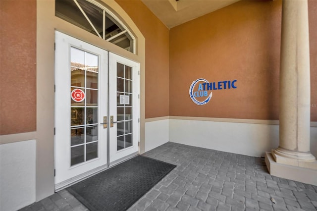 doorway to property with french doors and stucco siding