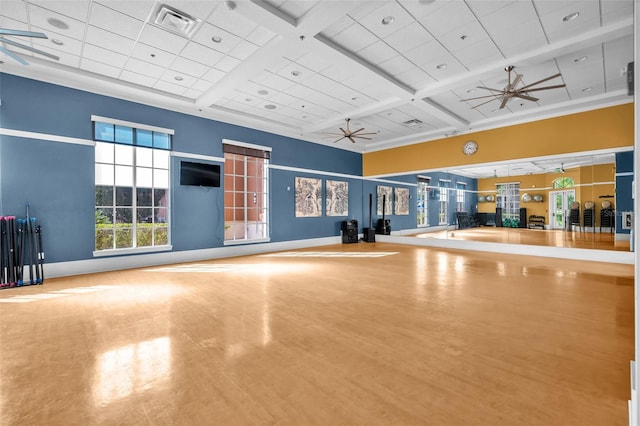 interior space featuring coffered ceiling, baseboards, ceiling fan, and wood finished floors