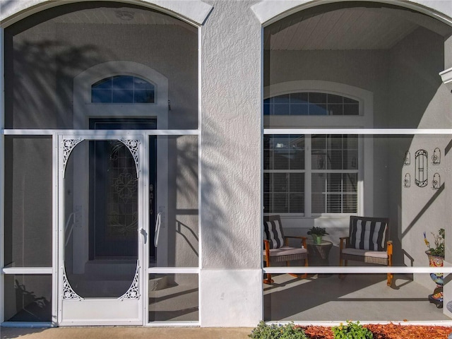 doorway to property with stucco siding